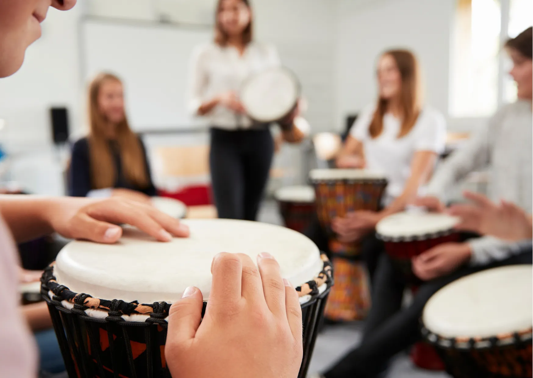Students participating in a drumming session at school